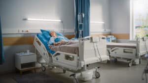 Woman lying in hospital bed after surgery